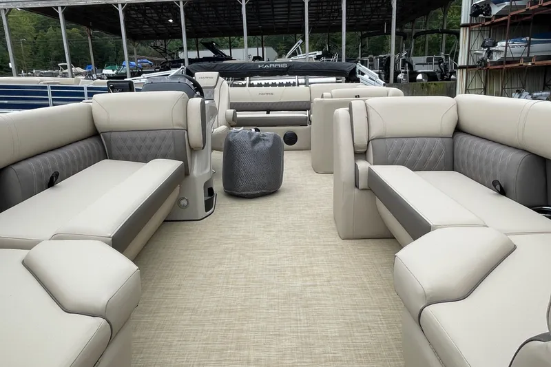 Slide: The Image of 2026 Harris Cruiser 230 pontoon boat interior with beige seating and spacious layout. - 3