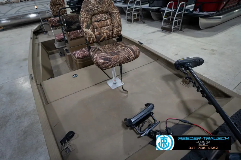 Slide: The Image of 2007 G3 1860 CCT boat with camo seats and trolling motor in showroom. - 12