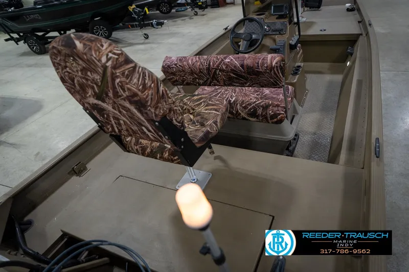 Slide: The Image of 2007 G3 1860 CCT boat with camouflage seats in showroom, Reeder-Trausch Marine logo visible. - 13