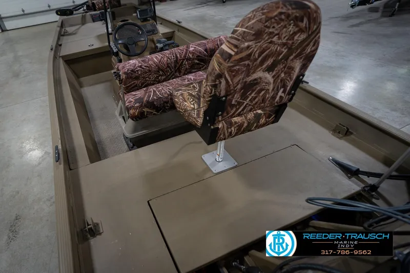 Slide: The Image of 2007 G3 1860 CCT boat interior with camo seats and steering wheel. - 14