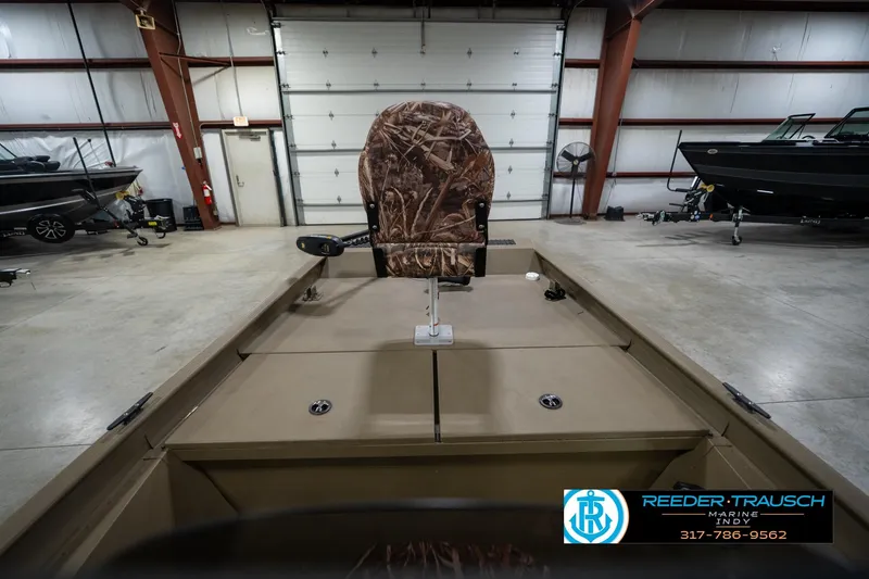 Slide: The Image of 2007 G3 1860 CCT boat in a showroom, featuring camo seat and spacious deck. - 16