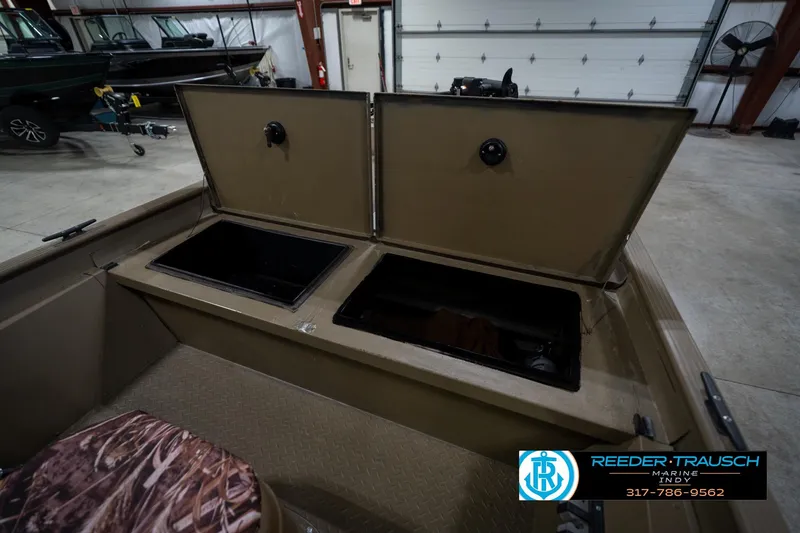 Slide: The Image of 2007 G3 1860 CCT boat storage compartments open in a showroom. - 21