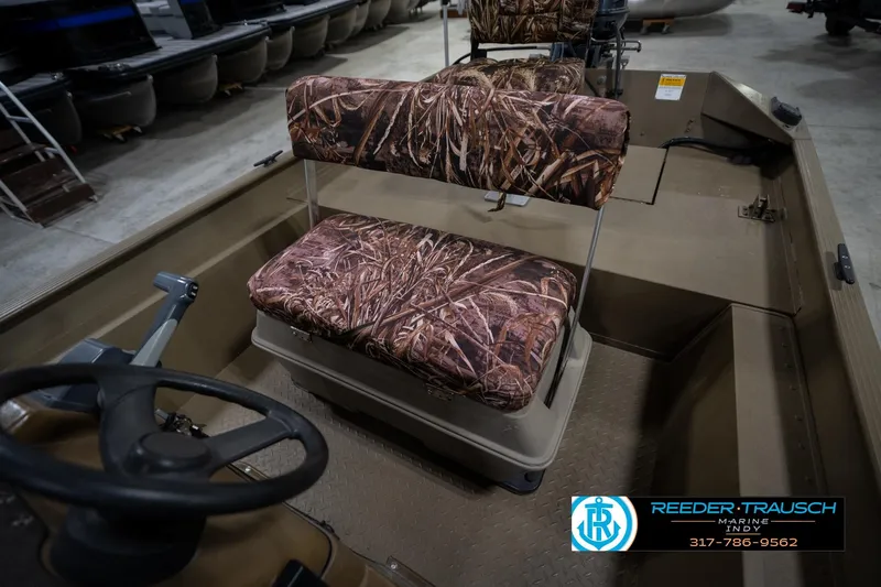Slide: The Image of 2007 G3 1860 CCT boat interior with camo seats, steering wheel, and Reeder-Trausch Marine logo. - 22