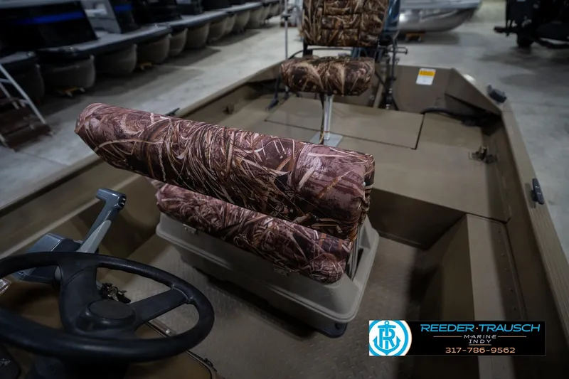 Slide: The Image of 2007 G3 1860 CCT boat interior with camo seats and steering wheel. - 23