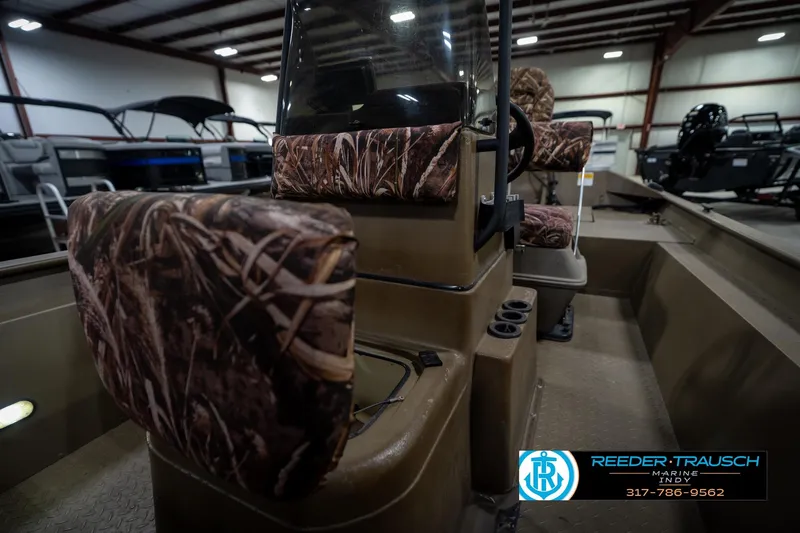 Slide: The Image of 2007 G3 1860 CCT boat interior with camouflage seats in a showroom. - 27