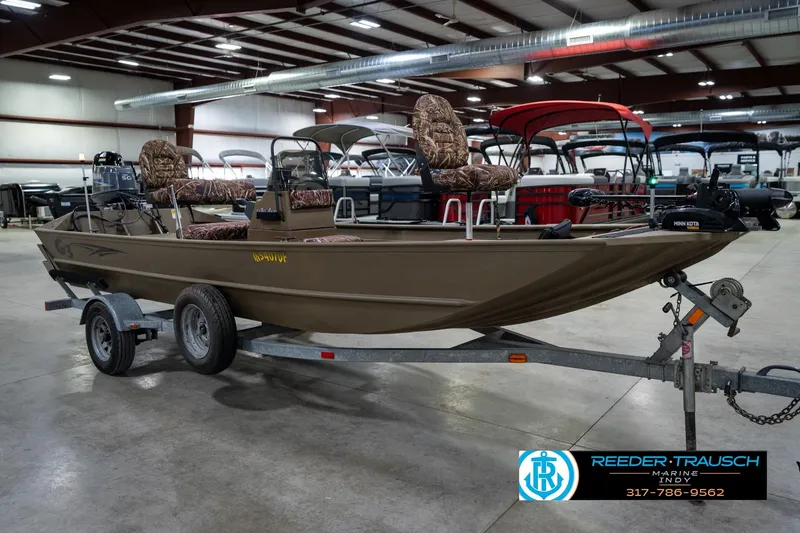 Slide: The Image of 2007 G3 1860 CCT boat on trailer in indoor showroom, featuring camo seats. - 5