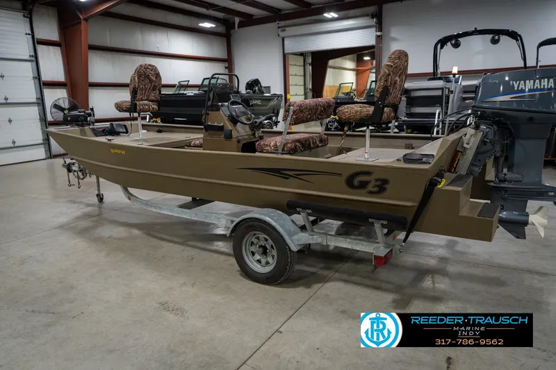 Slide: The Image of 2007 G3 1860 CCT boat on trailer in indoor showroom, featuring camo seats and Yamaha motor. - 9