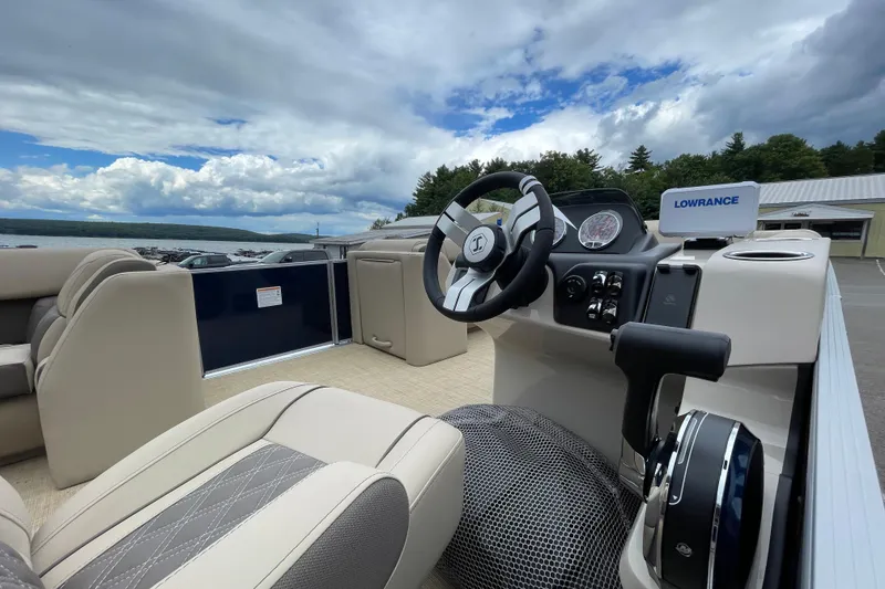 Slide: The Image of 2026 Harris Cruiser 230 boat interior with steering wheel and Lowrance navigation system. - 12