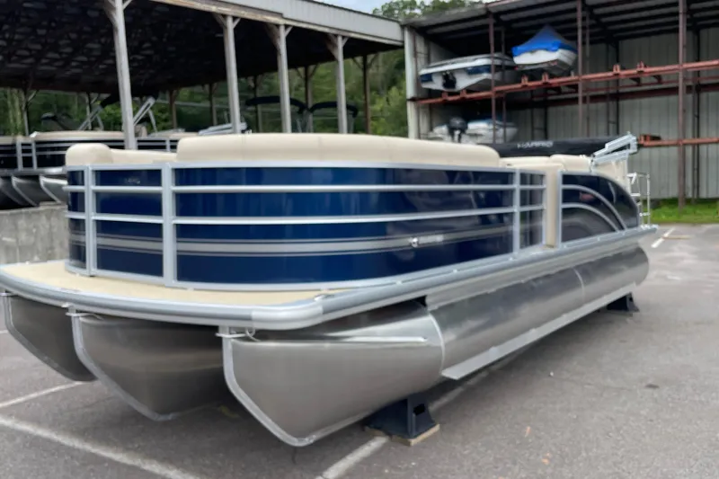 Slide: The Image of 2026 Harris Cruiser 230 pontoon boat in a storage facility. - 7