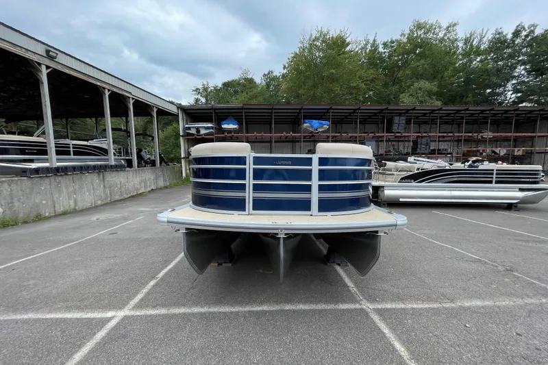 Slide: The Image of 2026 Harris Cruiser 230 pontoon boat in storage lot, front view. - 9