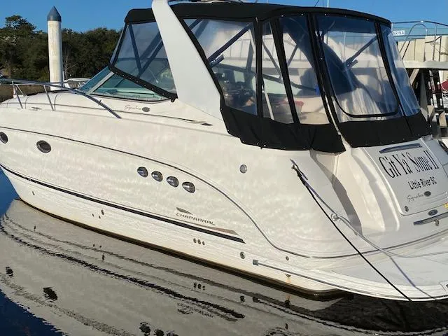 The Image of 2004 Chaparral Signature 350 boat docked, featuring sleek design and black canopy. - 0