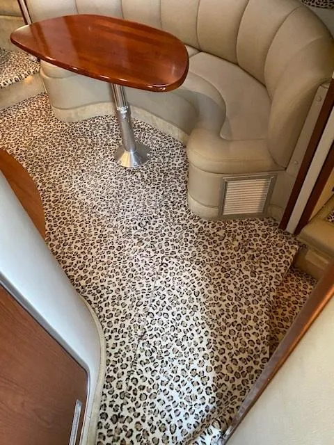 Slide: The Image of 2004 Chaparral Signature 350 interior with leopard print carpet and curved seating. - 11