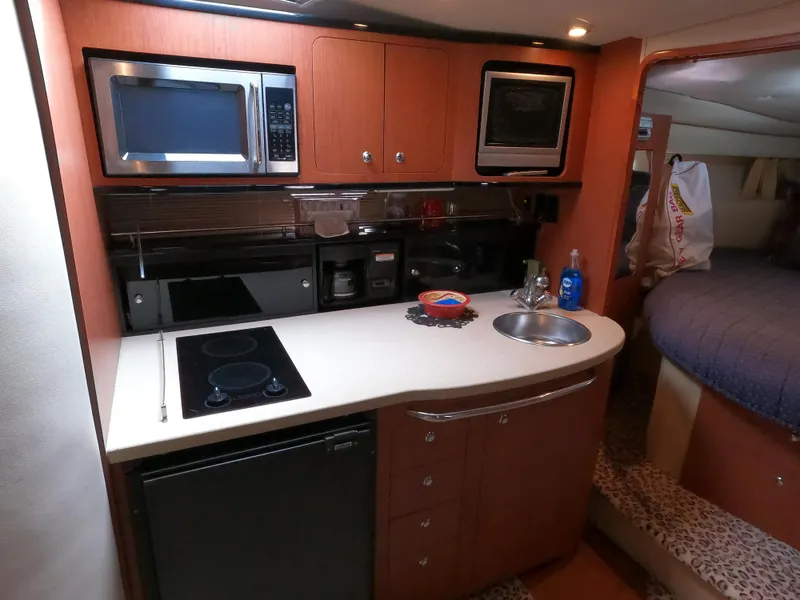 Slide: The Image of 2004 Chaparral Signature 350 yacht kitchen with modern appliances and cozy interior. - 12