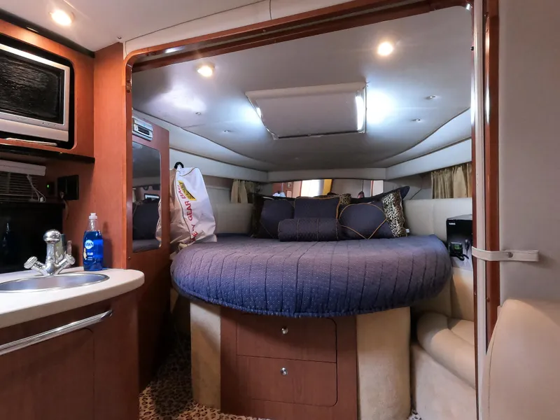 Slide: The Image of Interior of 2004 Chaparral Signature 350 yacht with cozy bed and kitchenette. - 13