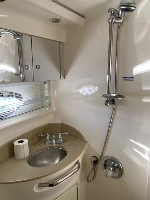 Slide: The Image of 2004 Chaparral Signature 350 bathroom with sink, shower, and storage cabinets. - 19