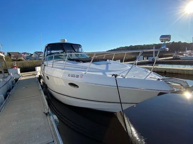 Slide: The Image of 2004 Chaparral Signature 350 boat docked in a marina under clear blue skies. - 2