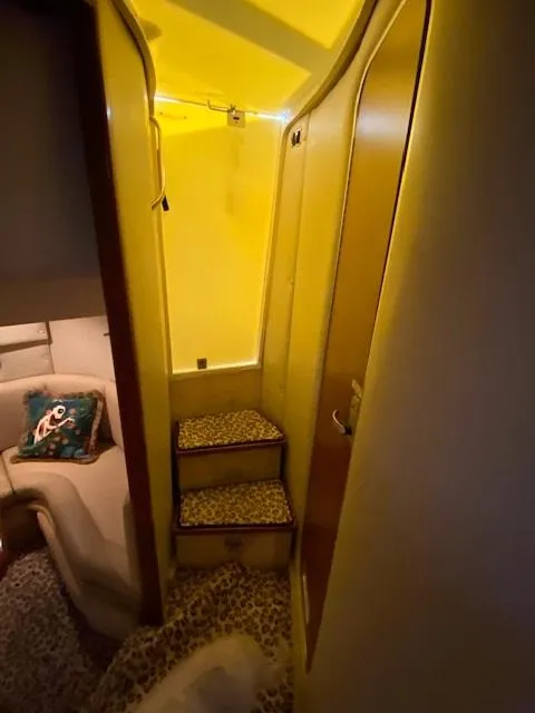 Slide: The Image of Interior of 2004 Chaparral Signature 350 yacht with cozy seating and carpeted steps. - 21