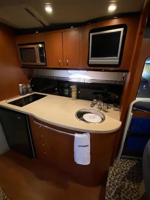 Slide: The Image of 2004 Chaparral Signature 350 yacht kitchen with modern appliances and sleek design. - 23