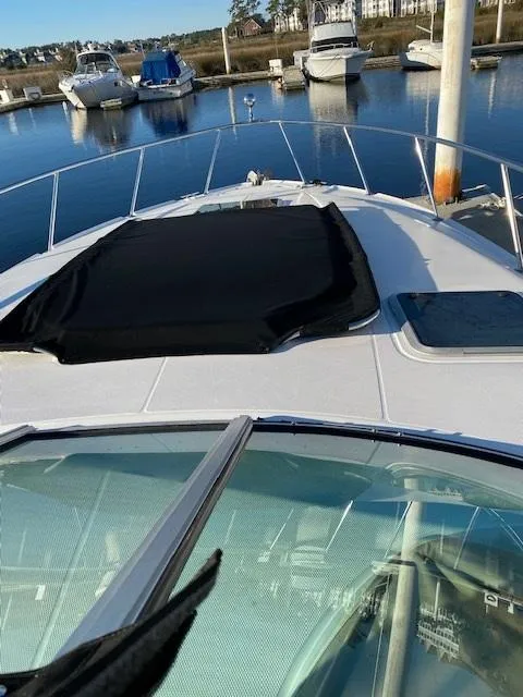 Slide: The Image of 2004 Chaparral Signature 350 yacht docked at marina with scenic water view. - 5