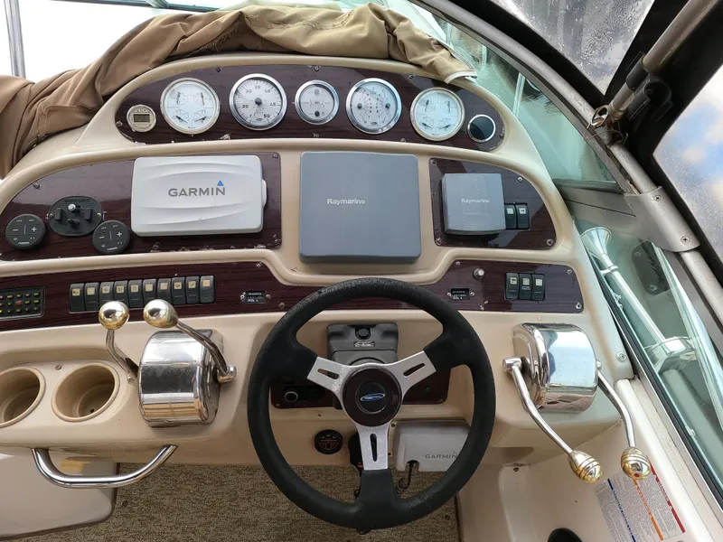 Slide: The Image of 2004 Chaparral Signature 350 boat dashboard with Garmin and Raymarine navigation systems. - 6
