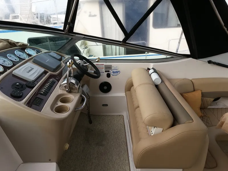 Slide: The Image of 2004 Chaparral Signature 350 boat interior with steering wheel and beige seating. - 7