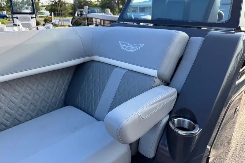 Slide: The Image of Luxurious seating on 2026 Bennington 24 MFB boat with elegant stitching and armrest. - 13