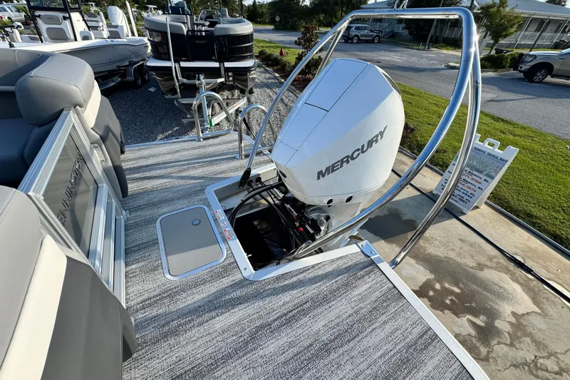 Slide: The Image of 2026 Bennington 24 MFB boat with Mercury engine, docked on a sunny day. - 25