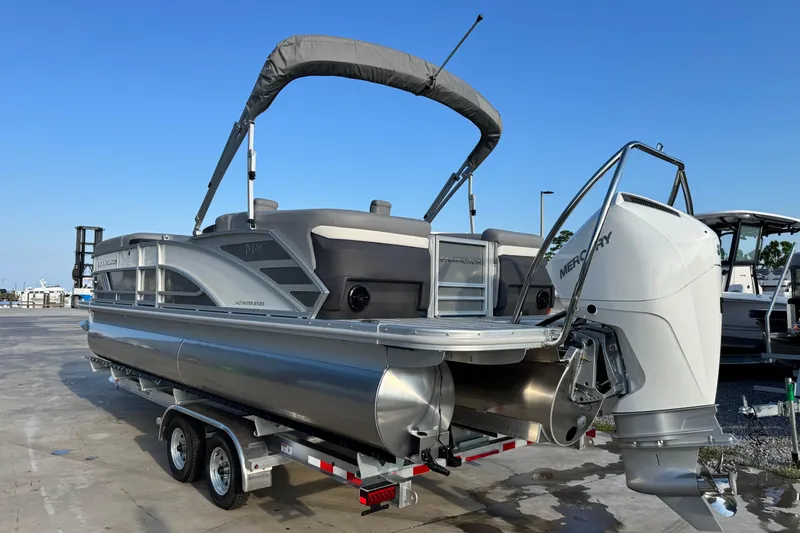 Slide: The Image of 2026 Bennington 24 MFB pontoon boat with Mercury outboard motor on trailer. - 4