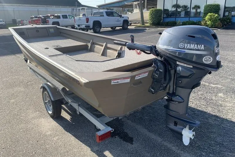 Slide: The Image of 2025 SeaArk DXS 1548 DKLD boat with Yamaha outboard motor on trailer. - 1