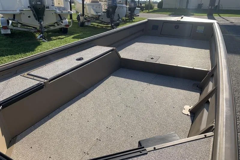 Slide: The Image of 2025 SeaArk DXS 1548 DKLD boat interior with spacious deck and storage compartments. - 10