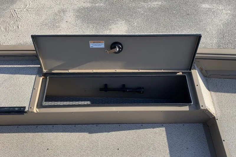 Slide: The Image of Open storage compartment on 2025 SeaArk DXS 1548 DKLD boat, showing interior details. - 11