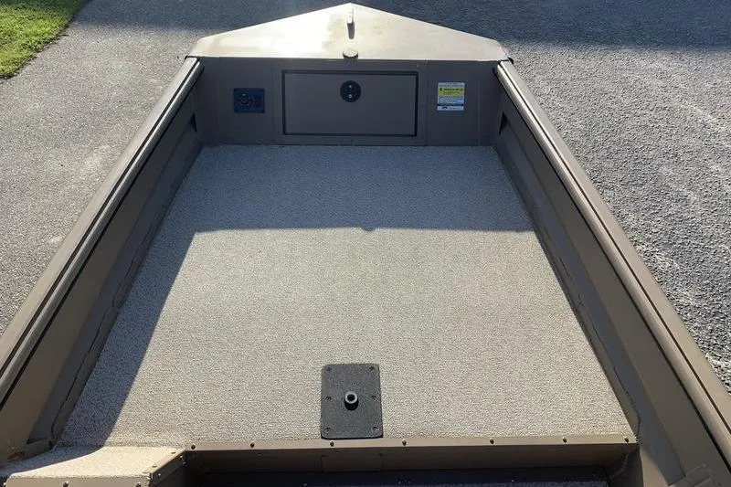 Slide: The Image of 2025 SeaArk DXS 1548 DKLD boat interior with spacious deck and storage compartment. - 12