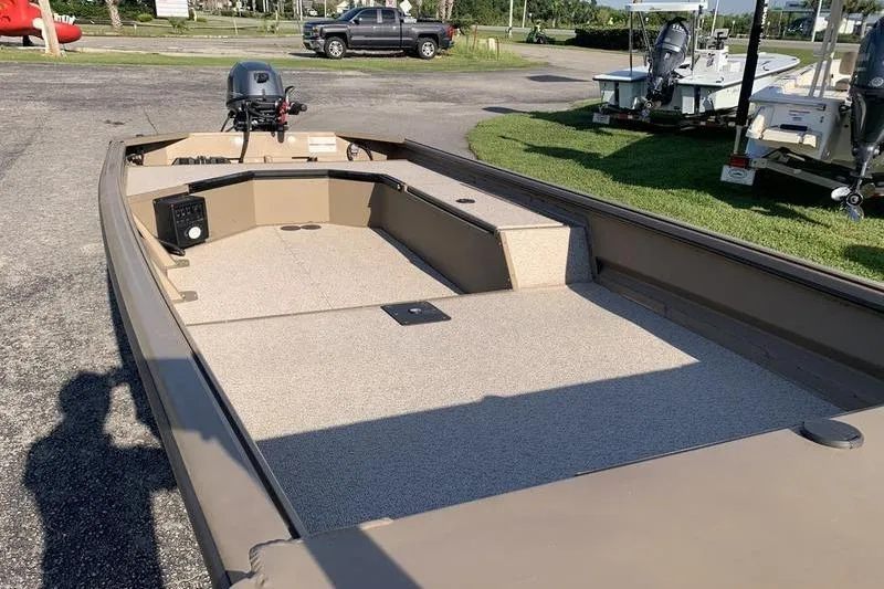 Slide: The Image of 2025 SeaArk DXS 1548 DKLD boat with spacious deck and outboard motor. - 14