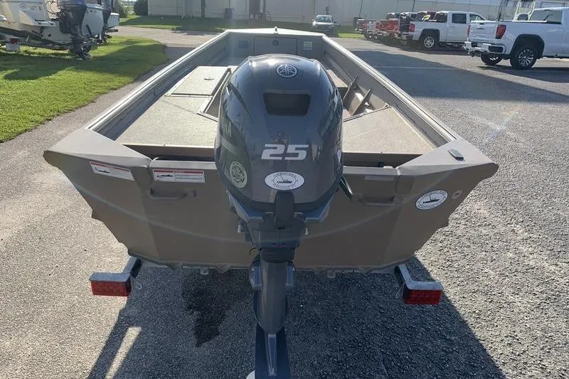 Slide: The Image of 2025 SeaArk DXS 1548 DKLD boat with Yamaha 25 outboard motor on trailer. - 2