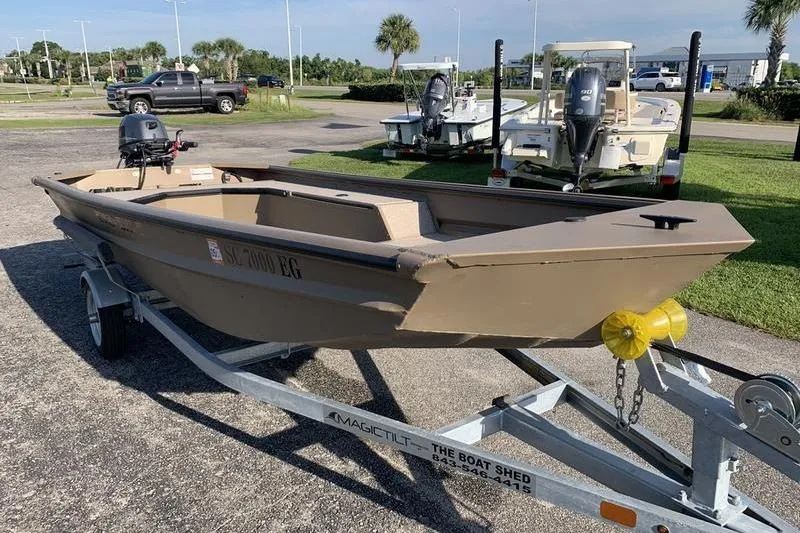 Slide: The Image of 2025 SeaArk DXS 1548 DKLD boat on trailer in outdoor setting. - 5