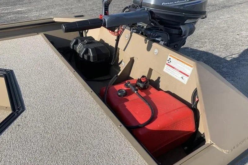 Slide: The Image of 2025 SeaArk DXS 1548 DKLD boat interior with motor and fuel tank. - 8