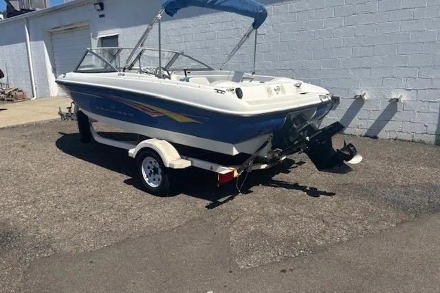 Slide: The Image of 2007 Bayliner 175 Bowrider boat on trailer, parked outdoors in a sunny setting. - 2