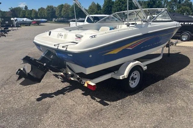 Slide: The Image of 2007 Bayliner 175 Bowrider boat, rear view, parked on a trailer in a sunny outdoor setting. - 3