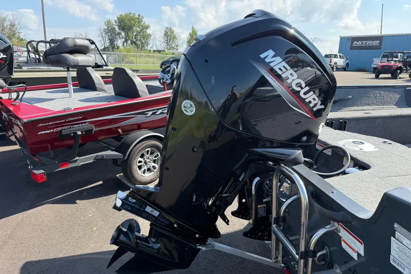 Slide: The Image of 2022 Tracker PGV16SC boat with Mercury outboard motor, parked outdoors. - 2