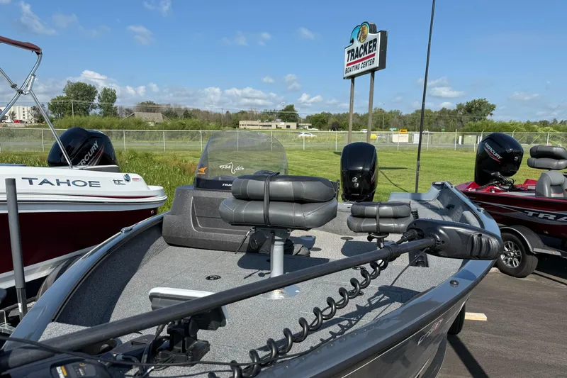 Slide: The Image of 2022 Tracker PGV16SC boat displayed at Tracker Boating Center under clear blue sky. - 6