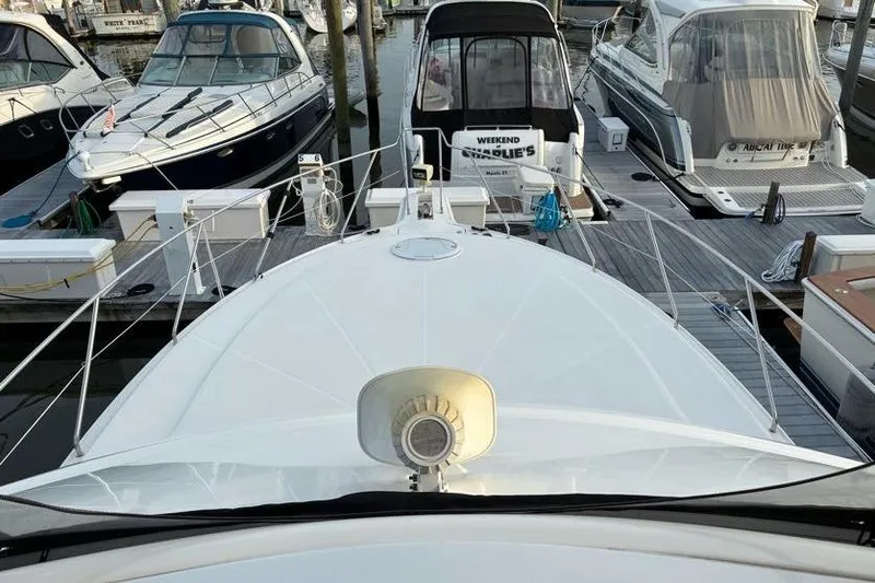 Slide: The Image of 2005 Silverton 34 Convertible yacht docked among other boats at a marina. - 11