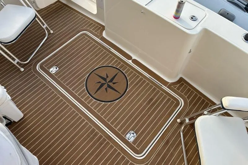 Slide: The Image of 2005 Silverton 34 Convertible boat deck with compass design and seating. - 12