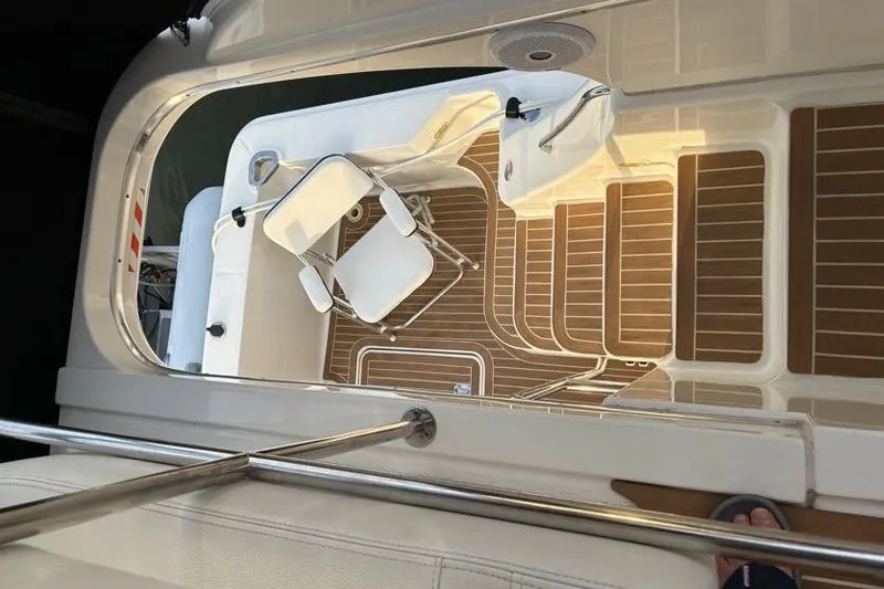 Slide: The Image of 2005 Silverton 34 Convertible boat deck with seating and wood-patterned flooring. - 13