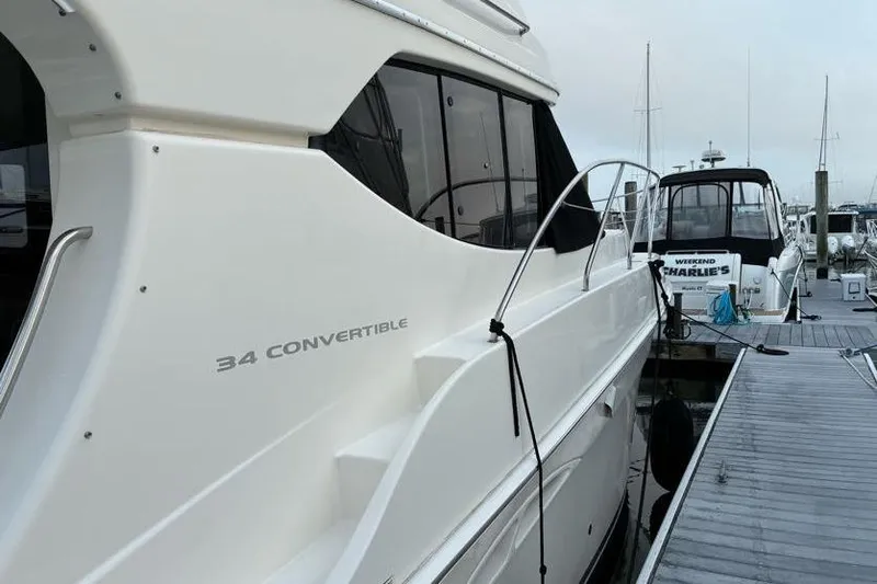 Slide: The Image of 2005 Silverton 34 Convertible yacht docked at marina, side view. - 14