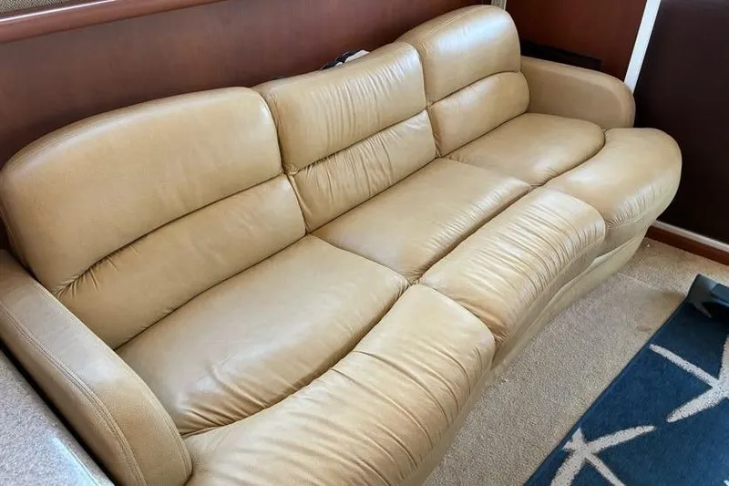 Slide: The Image of Beige leather sofa inside 2005 Silverton 34 Convertible yacht interior. - 16