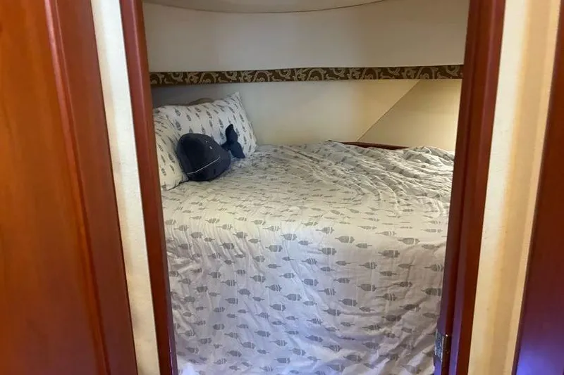 Slide: The Image of Cozy bedroom in 2005 Silverton 34 Convertible yacht with nautical-themed bedding. - 21
