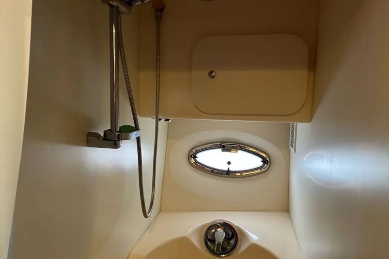 Slide: The Image of 2005 Silverton 34 Convertible boat bathroom with shower and porthole window. - 24