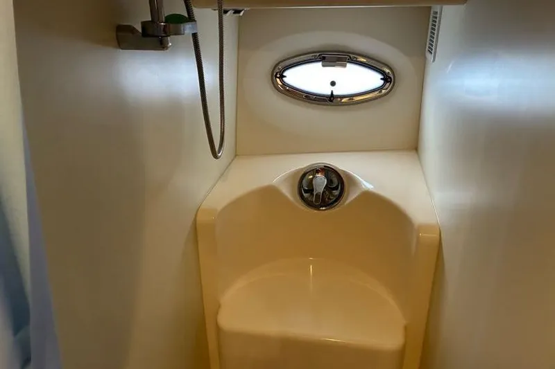 Slide: The Image of 2005 Silverton 34 Convertible yacht bathroom with shower and porthole window. - 25