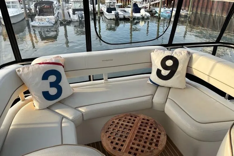 Slide: The Image of 2005 Silverton 34 Convertible yacht interior with numbered cushions and marina view. - 3