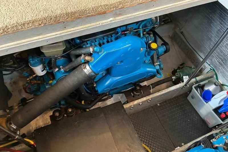 Slide: The Image of Engine compartment of a 2005 Silverton 34 Convertible boat, showcasing a blue engine. - 31